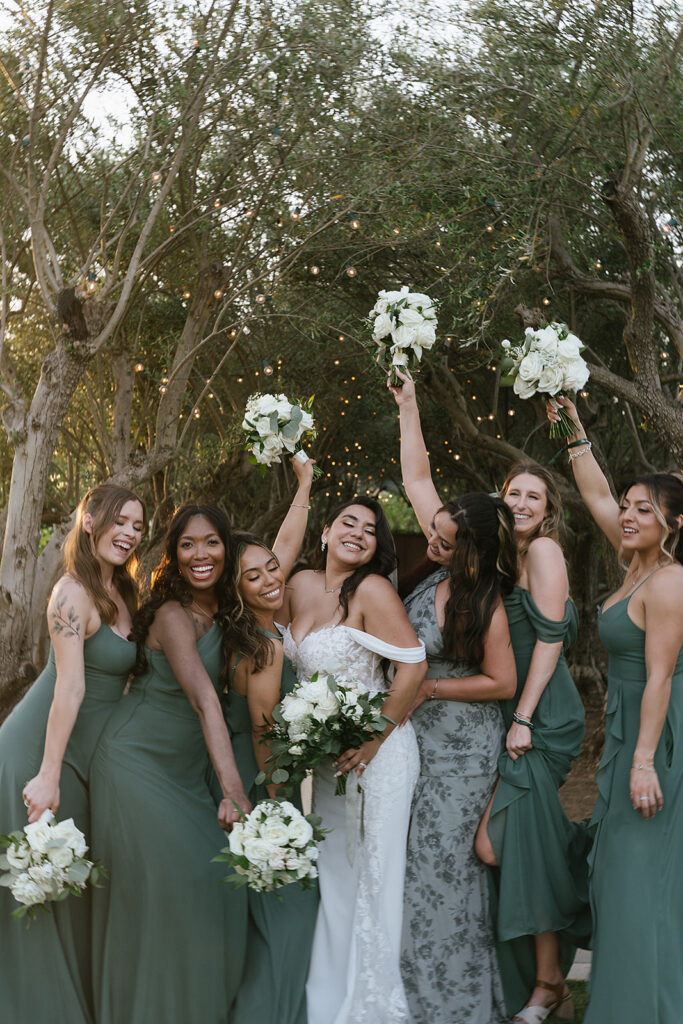 bride with bridesmaids laughing and smiling
